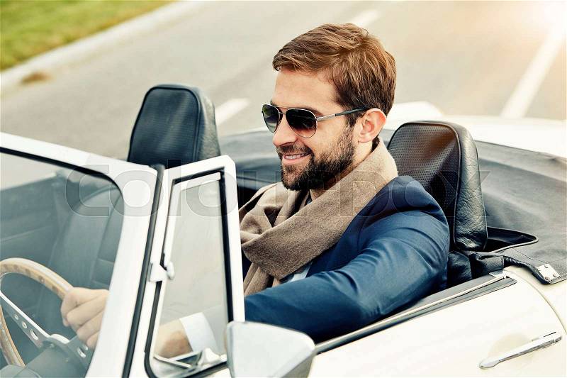 Sports car guy in shades, smiling, stock photo