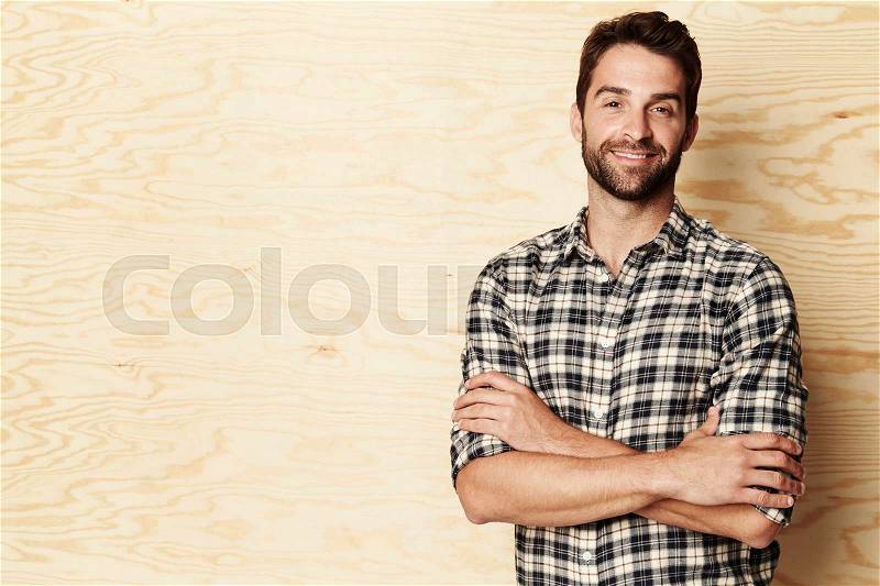 Smiling man in checked shirt, portrait, stock photo