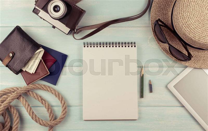 Travel set for tourist with documents, hat, photo camera, binoculars, notebook, and money on wooden background. Journey concept for holidays. Top view. Flat lay. Empty place for text, stock photo