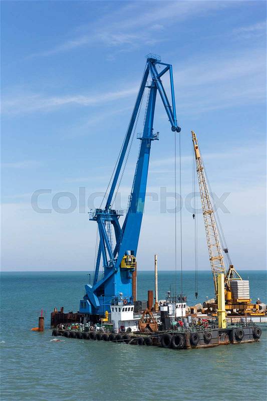 Crane barge doing marine heavy lift installation works in the gulf or the sea, stock photo
