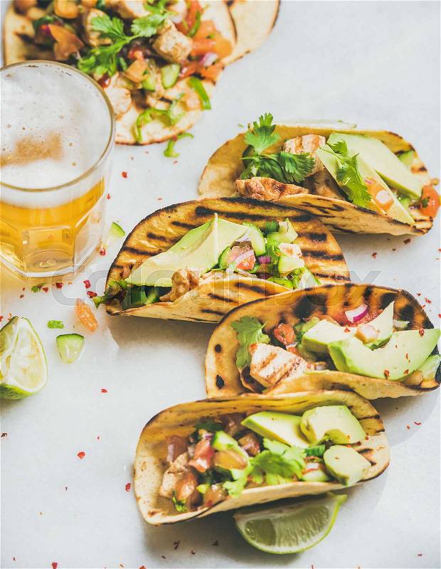 Healthy corn tortillas with grilled chicken fillet, avocado and beer, stock photo