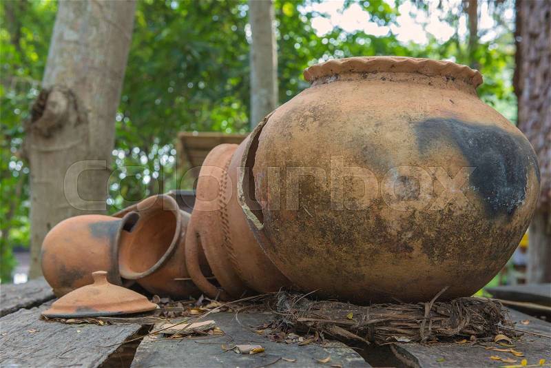 Broken antique clay pot or traditional Jar on abandoned hut, stock photo