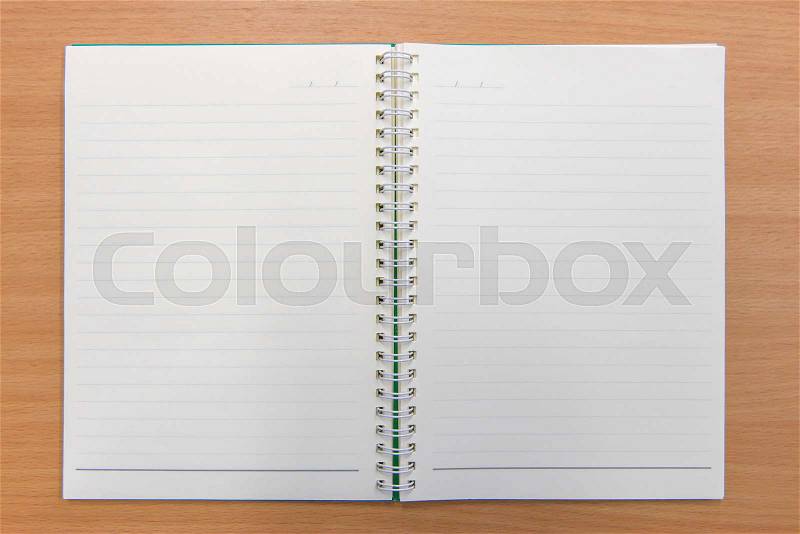 Notebook paper with on wooden background, stock photo