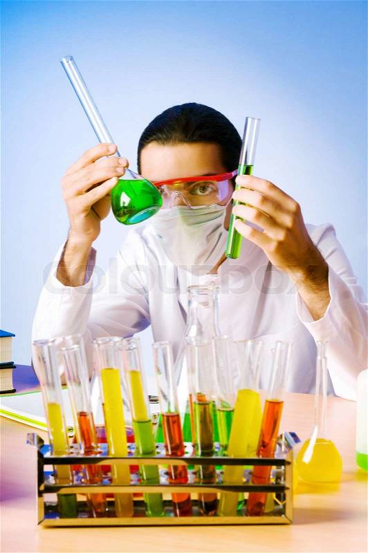 Chemist in the lab experimenting with solutions, stock photo