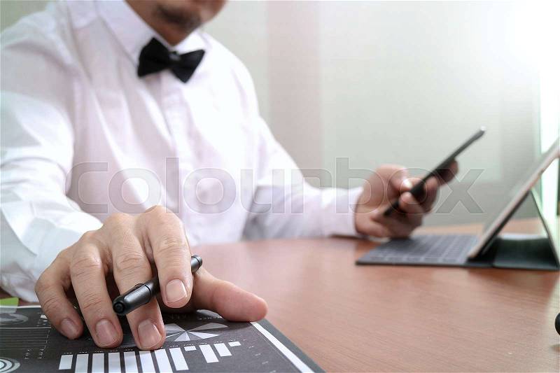 Justice and Law context.Male lawyer hand working with smart phone,digital tablet computer docking keyboard with gavel and document on wood table, stock photo