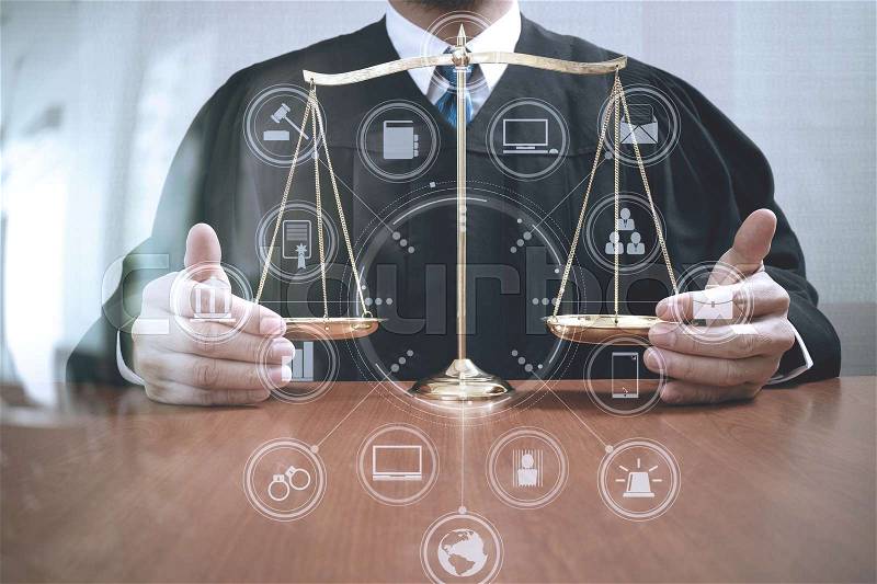 Justice and law concept.Male judge in a courtroom with the balance scale on wood table,virtual interface graphic icons diagram, stock photo
