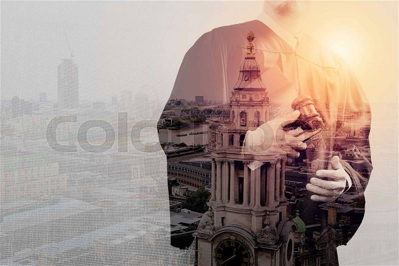 Double exposure of justice and law concept.Male judge in a courtroom with the gaveland holy book and digital tablet computer,London city, stock photo