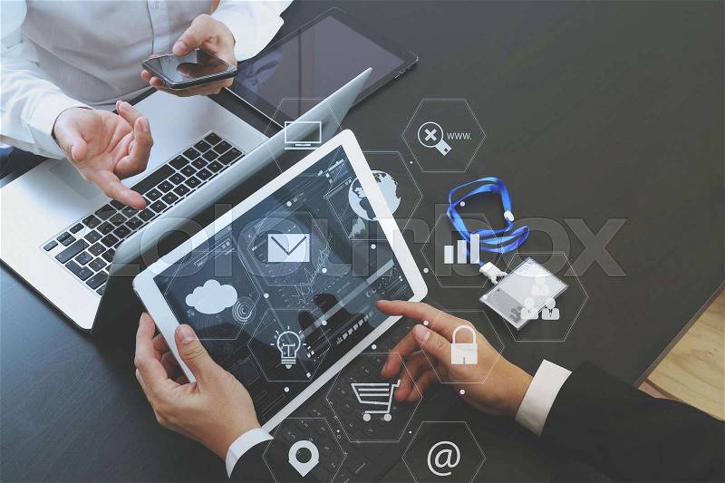 Co working team meeting concept,businessman using smart phone and digital tablet and laptop computer and name tag in modern office with virtual icon graph and chart, stock photo