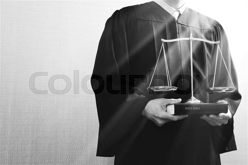 Justice and law concept.Male judge in a courtroom with the balance scale and holy book,black and white , stock photo