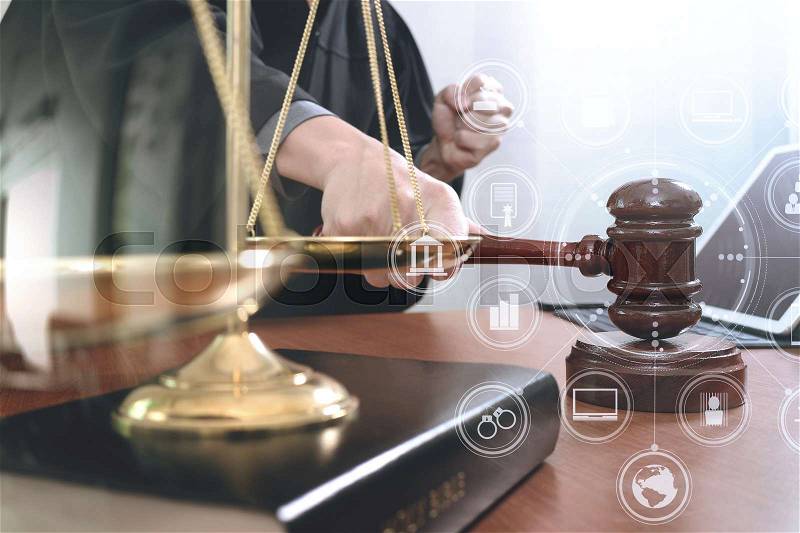 Justice and law concept.Male judge in a courtroom with the gavel,working with smart phone and digital tablet computer with brass scale on wood table with virtual interface graphic icons diagram , stock photo