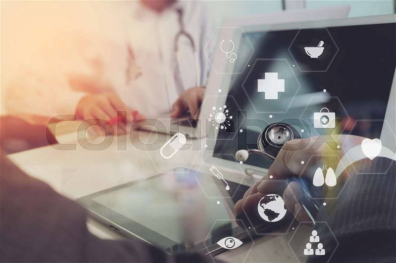 Medical co working concept,Doctor working with smart phone and digital tablet and laptop computer to meeting his team in modern office at hospital with virtual diagram, stock photo
