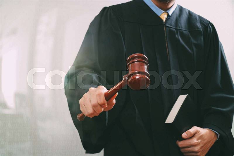 Justice and law concept.Male judge in a courtroom with the gavel and holy book , stock photo
