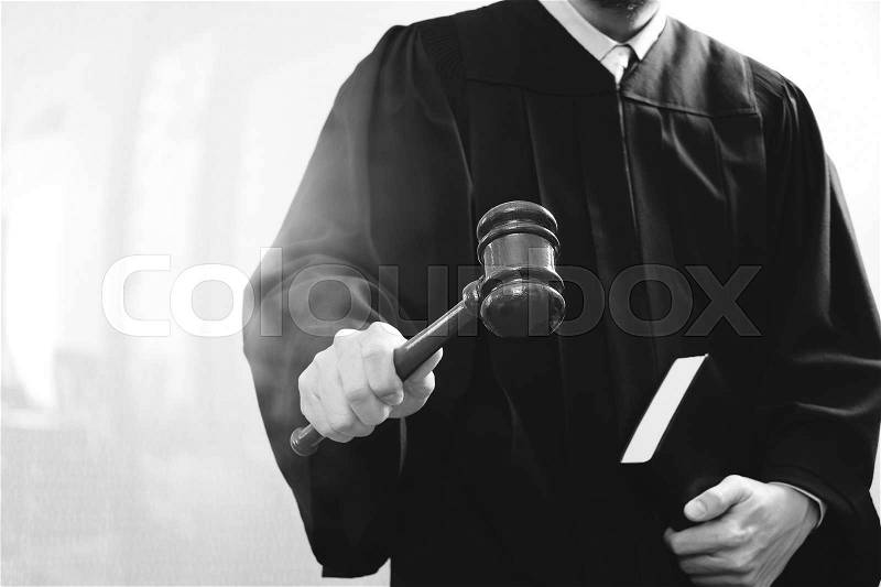 Justice and law concept.Male judge in a courtroom with the gavel and holy book,black and white , stock photo