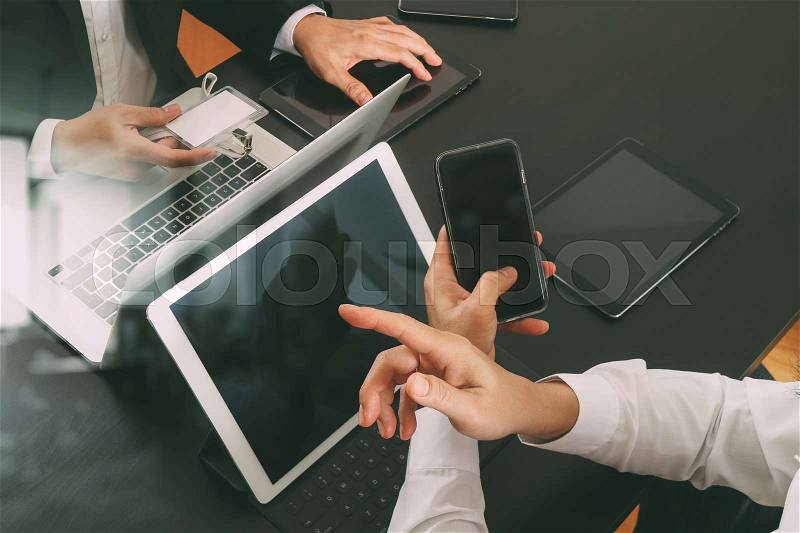 Co working team meeting concept,businessman using smart phone and digital tablet and laptop computer and name tag in modern office, stock photo