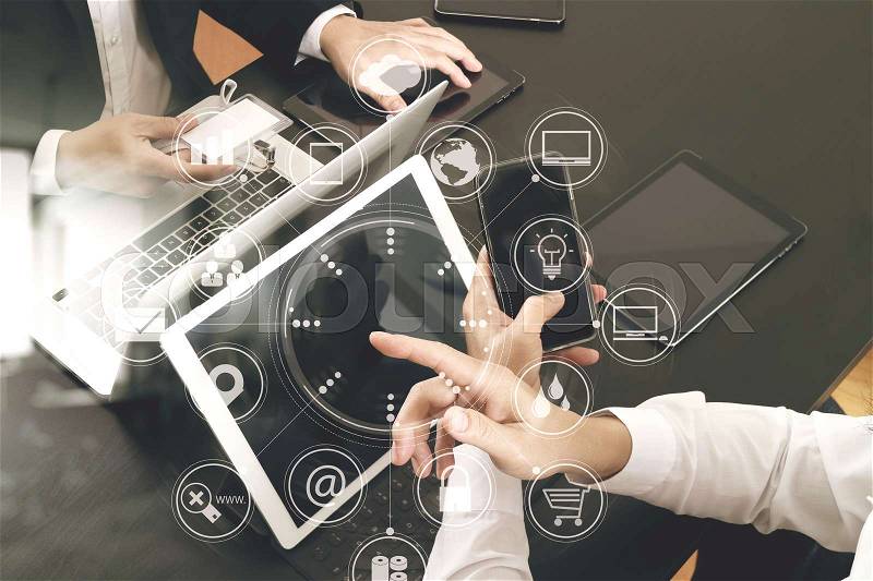Co working team meeting concept,businessman using smart phone and digital tablet and laptop computer and name tag in modern office with virtual icon graph and chart, stock photo