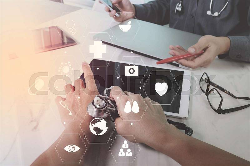 Medical co working concept,Doctor working with smart phone and digital tablet and laptop computer to meeting his team in modern office at hospital with virtual diagram, stock photo