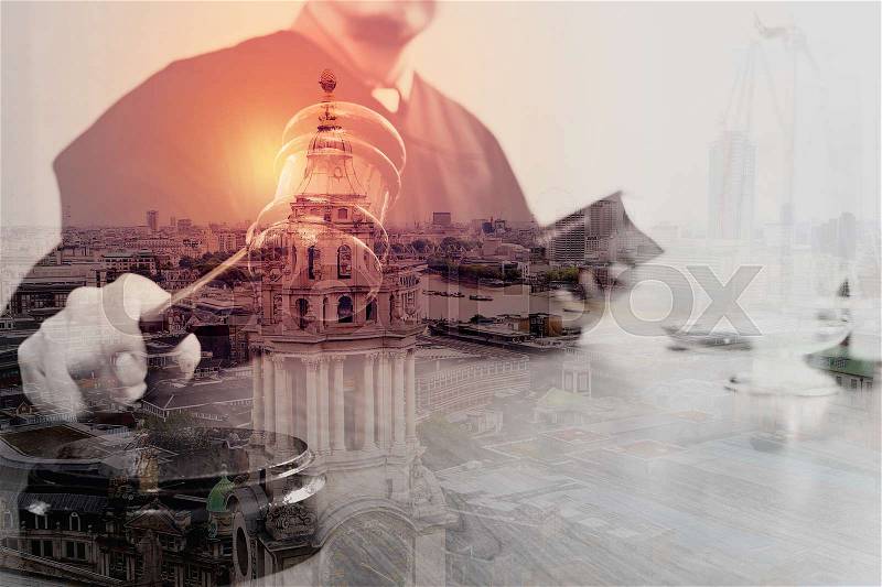 Double exposure of justice and law concept.Male judge in a courtroom with the gavel and working with smart phone and brass scale on wood table with London city, stock photo