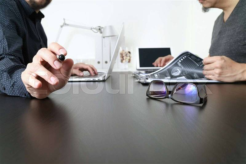 Business team meeting.Professional investor working new start up project and digital tablet docking keyboard and laptop computer with smart phone using and eyeglasses in modern office, stock photo