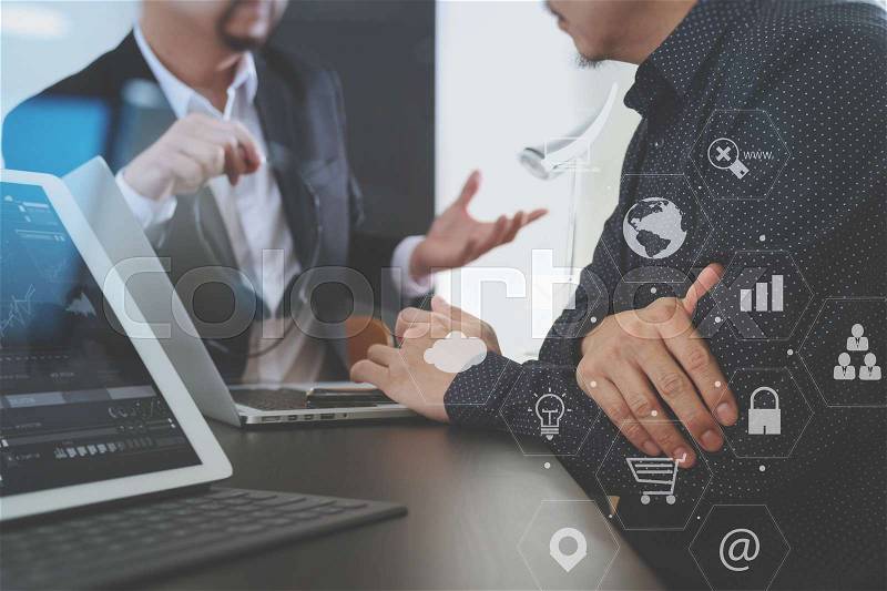 Co working team meeting concept,Man using VOIP headset with digital tablet and latop computer and smart phone in modern office with virtual graph chart and icon diagram, stock photo