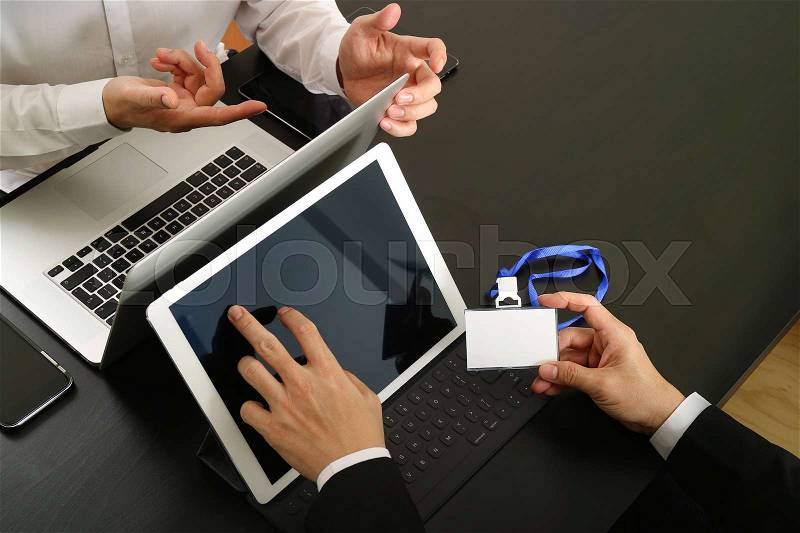Co working team meeting concept,businessman using smart phone and digital tablet and laptop computer and name tag in modern office, stock photo