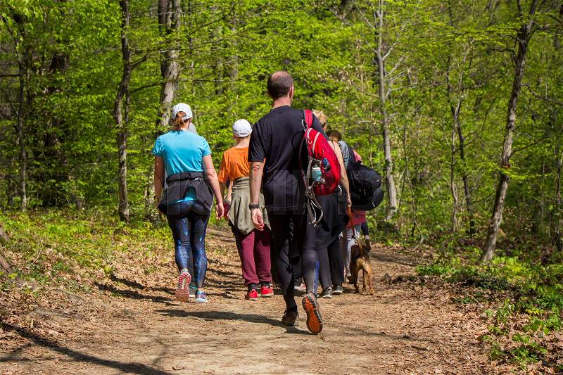 Group of people walking by hiking trail , stock photo
