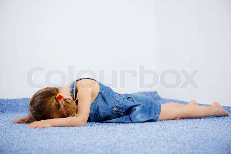 Crying child lying on the floor Stock Photo Colourbox