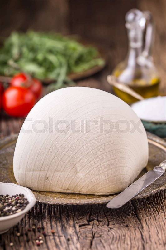 Cow Cheese. Fresh white cow cheese with lettuce salad radish salt pepper and olive oil, stock photo