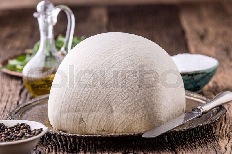 Cow Cheese. Fresh white cow cheese with lettuce salad radish salt pepper and olive oil, stock photo