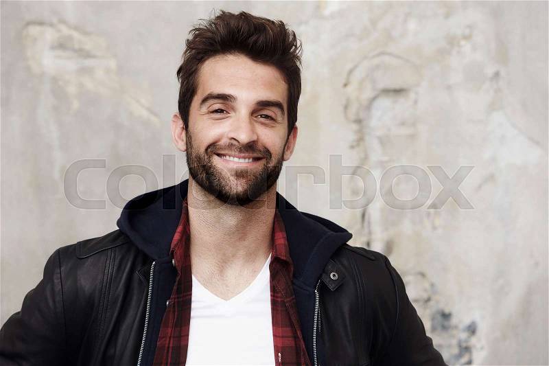 Smiling stubble man in leather jacket, portrait, stock photo
