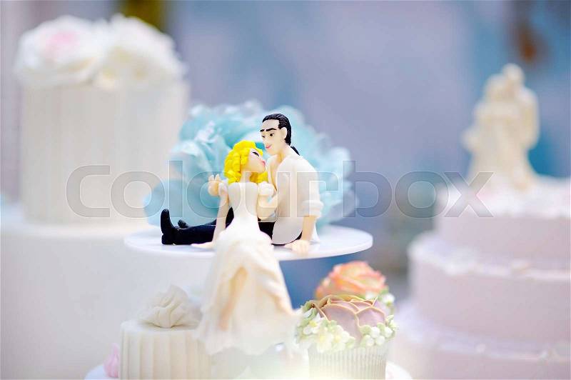 Funny figurines bride and groom. Sweet table for wedding party, stock photo