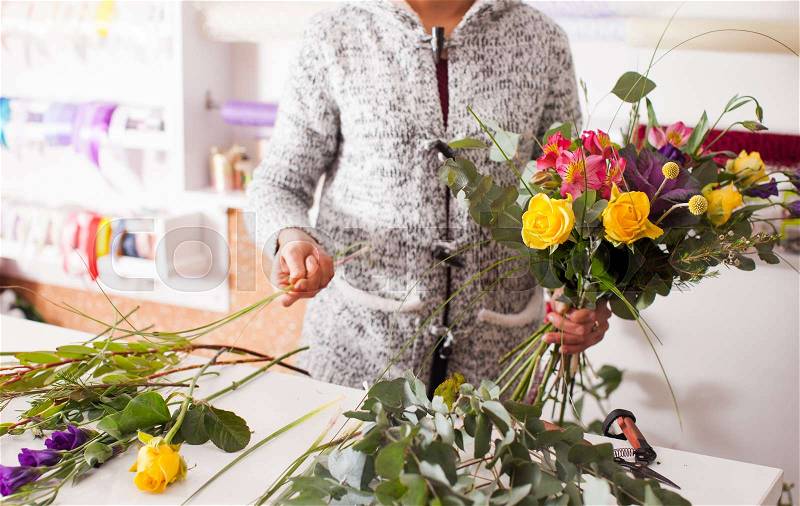 Florist making fashion bouquet of colorfull flowers, stock photo