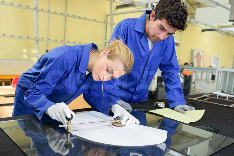 Young metallurgists at work in school workshop, stock photo