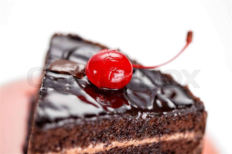 Fragment of a chocolate cake with a cherry isolated on white background, stock photo