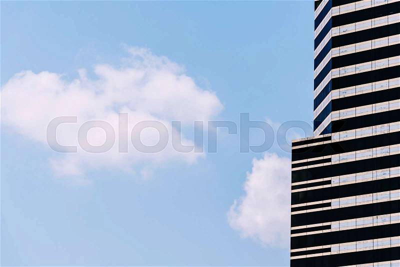 Glass office building with blue sky and white cloud. Architecture and business background, stock photo