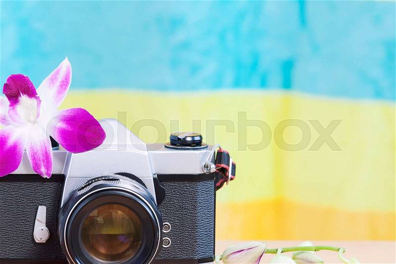 Vintage camera with bouquet of flowers on old wood background - concept of nostalgic and remembrance in spring vintage background, stock photo