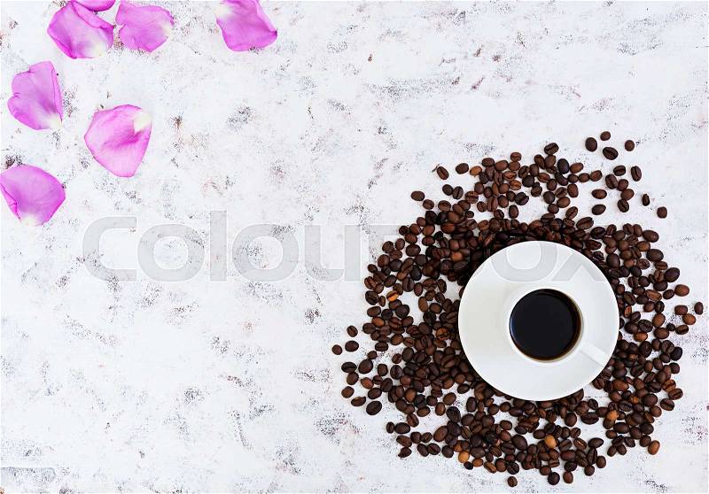 Coffee cup, coffee beans and rose petals on white background. Top view. Flat lay, stock photo