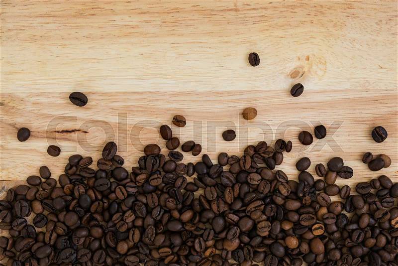 Mixture of different kinds of coffee beans on wooden background. Coffee background, stock photo