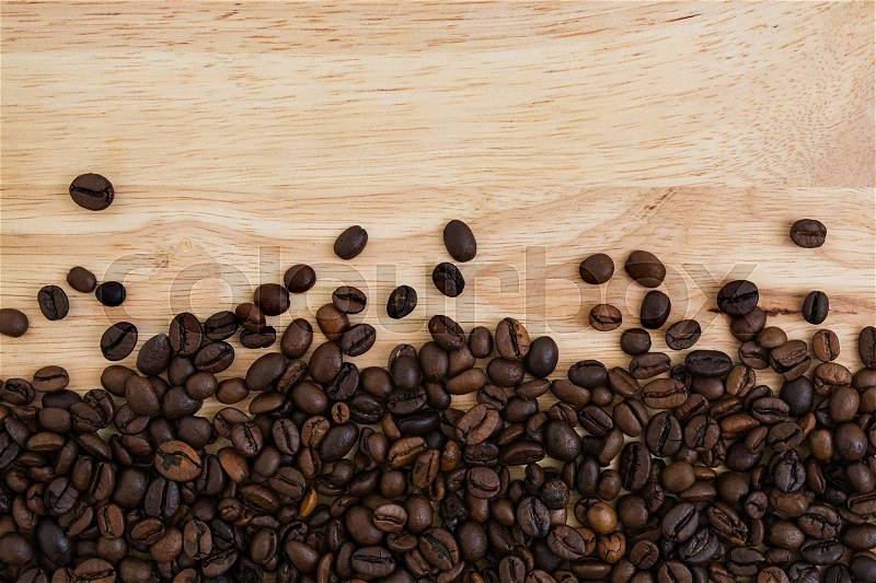 Mixture of different kinds of coffee beans on wooden background. Coffee background, stock photo