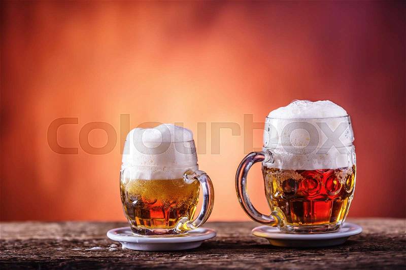 Beer. Two cold beers. Draft beer. Draft ale. Golden beer. Golden ale. Two gold beer with froth on top. Draft cold beer in glass jars in home pub hotel or restaurant. Empty beer glass. Still life, stock photo
