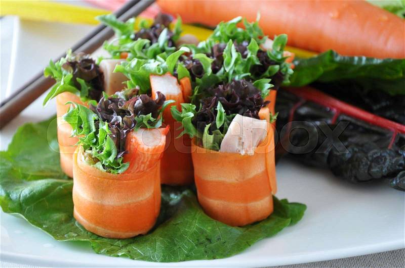 Fresh carrot rolls with veggie on plate, stock photo