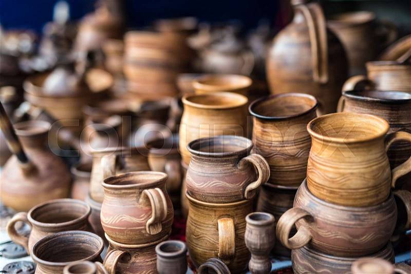 Lots of different wooden kitchenware at market on stall, stock photo