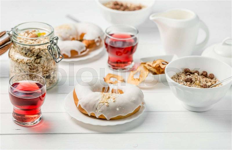 Luxurious breakfast with oats, apple chips, glazed croissant with chocolate and juice, milk on side, stock photo