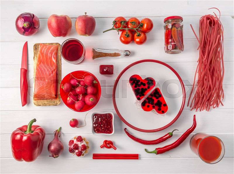 Set of red objects sitting on white table, salmon and pasta, pepper, raddish, topview, stock photo
