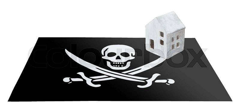 Small house on a flag - Pirate flag, stock photo