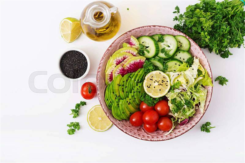 Diet menu. Healthy lifestyle. Vegan salad of fresh vegetables - tomatoes, cucumber, watermelon radish and avocado on bowl. Flat lay. Top view, stock photo