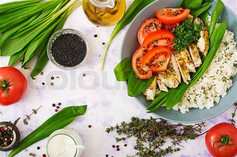 Healthy salad with chicken, tomatoes, wild garlic and rice. Proper nutrition. Dietary menu. Flat lay. Top view, stock photo