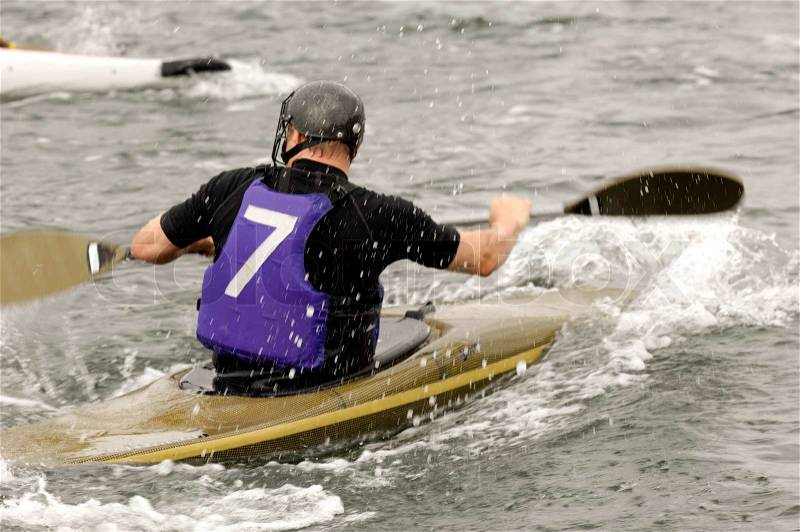 Man is racing in his kayak, stock photo