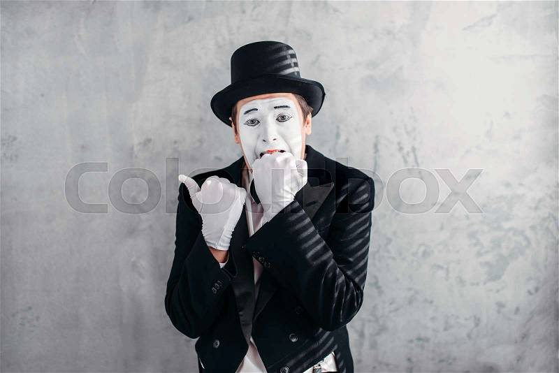 Mimic male person with white makeup mask. Comedy actor in suit, gloves and hat. Pantomime theater artist. April fools day concept, stock photo