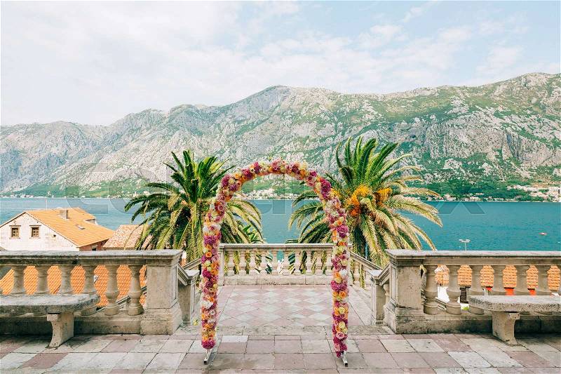 Wedding Arch of hydrangeas and roses. Wedding ceremony in the Bay of Kotor, in Montenegro, in the territory of the church of the Nativity of the Virgin in Prcanj, stock photo