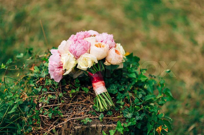 Wedding roses and peonies on a stump with ivy. Wedding in Montenegro, stock photo